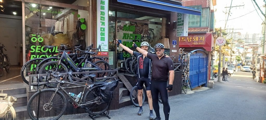 two customers pointing to Korea Seoul Bike Rental shop